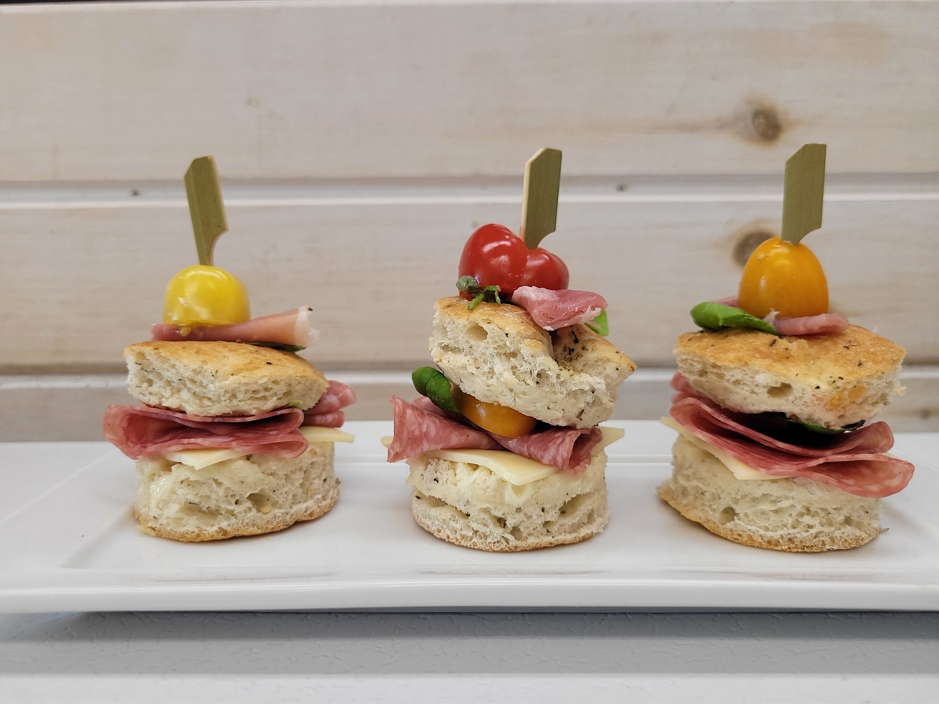 Mini focaccia slider canapés on skewers with heirloom tomatoes