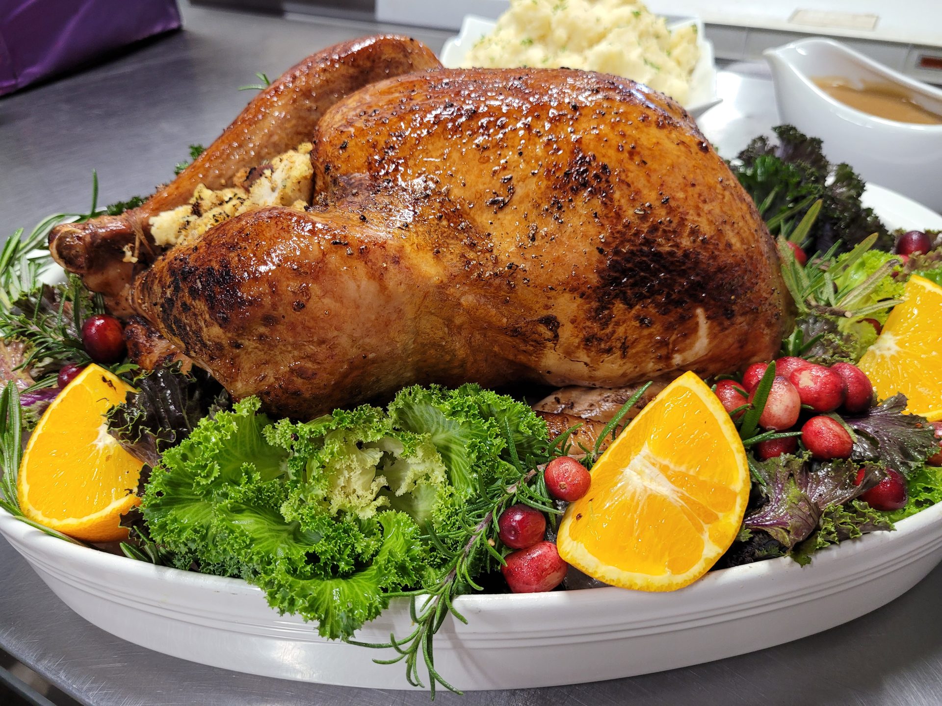 Herb-roasted turkey close-up with rosemary and cranberry garnish